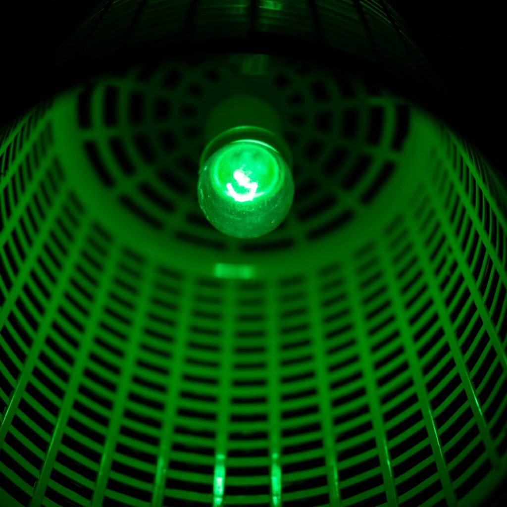 green utility lamp to colorful light on dark night background