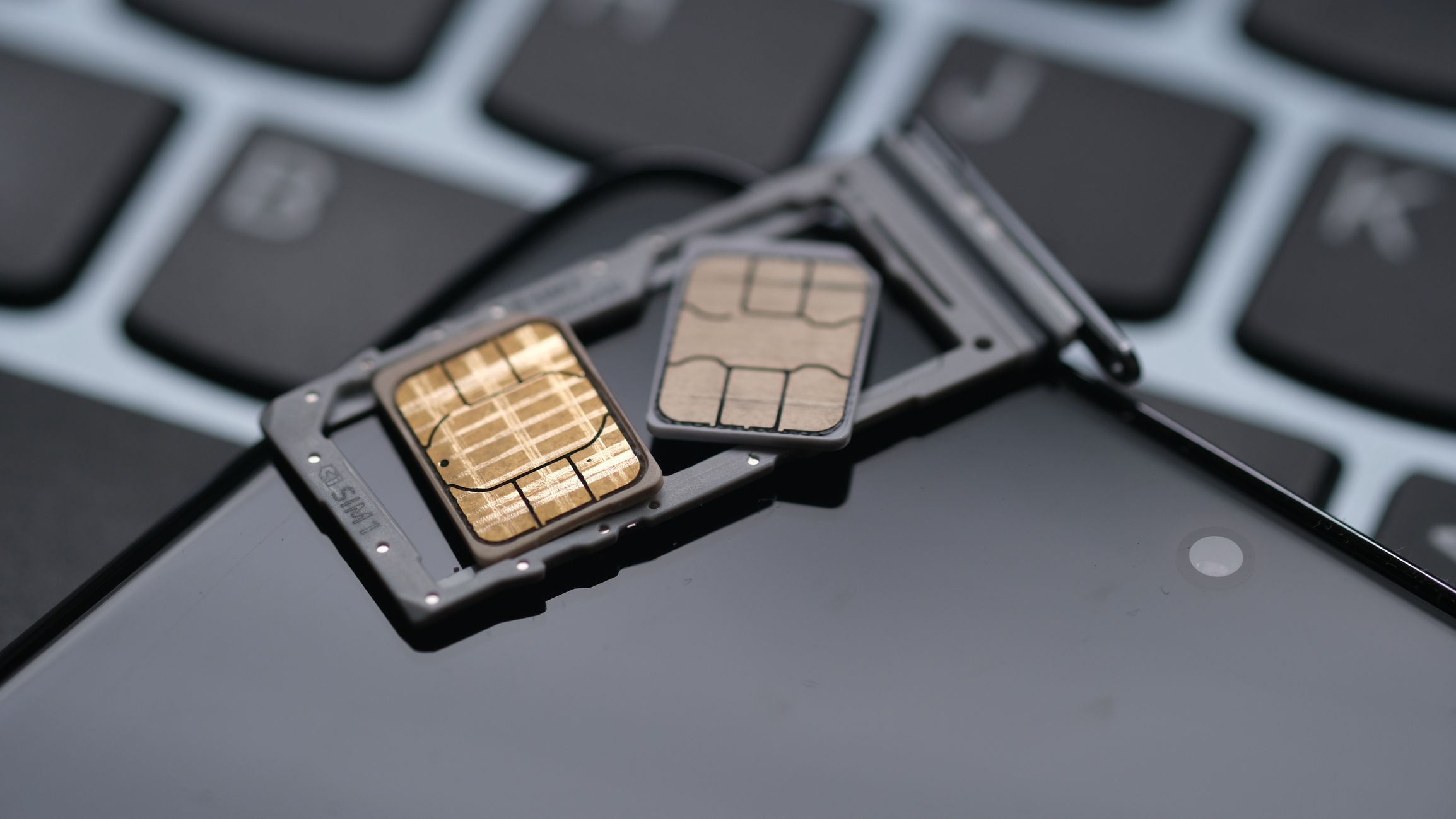 Dual nano Sim card on a smartphone and laptop