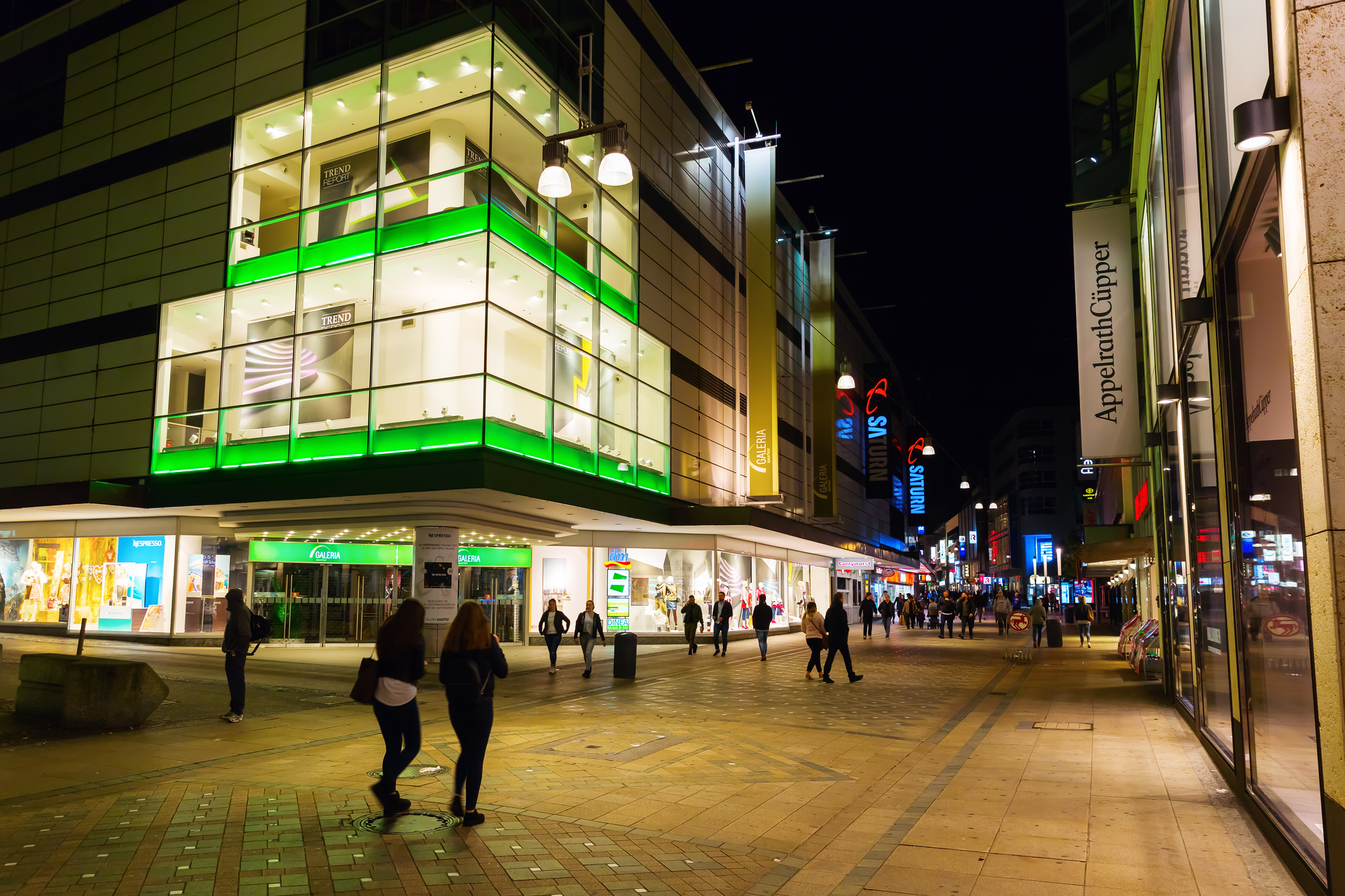 shopping street at night with neon green lights